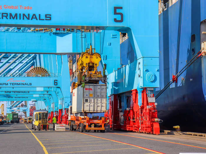 Trucks wait alongside the ship to receive their containers and then bring them elsewhere in the port where they