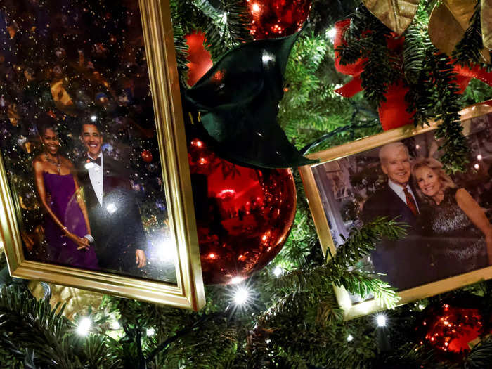 Christmas trees in the State Dining Room feature photos of the Bidens, as well as past presidential families.