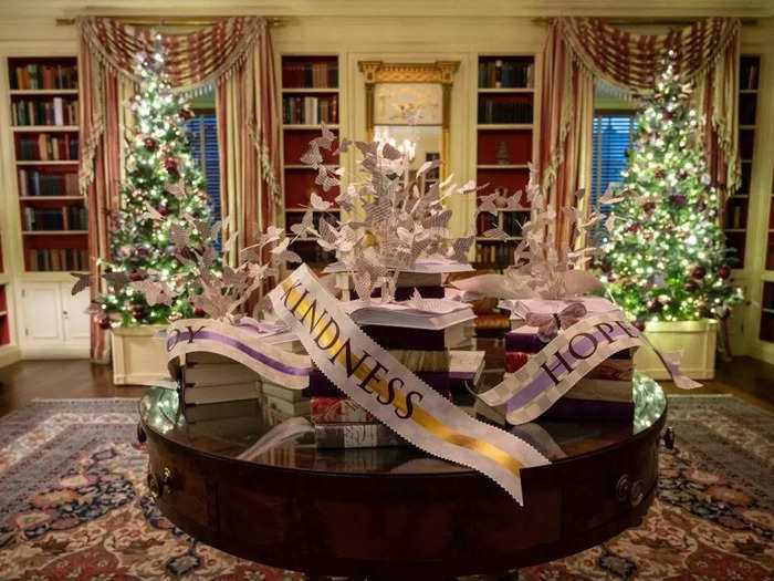 The Library is decorated with butterflies and birds made of recycled newspapers, as well as ribbons reading "Hope," "Kindness," and "Joy."