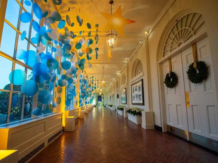 In the East Colonnade, clear blue circles line the windows and glowing stars hang from the ceiling.