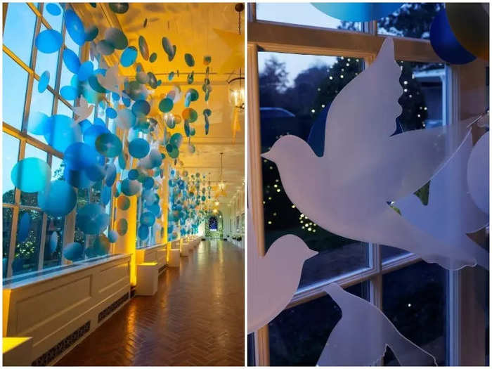 In the East Colonnade, cutouts of doves hang amid the clear blue window decorations, symbolizing peace.