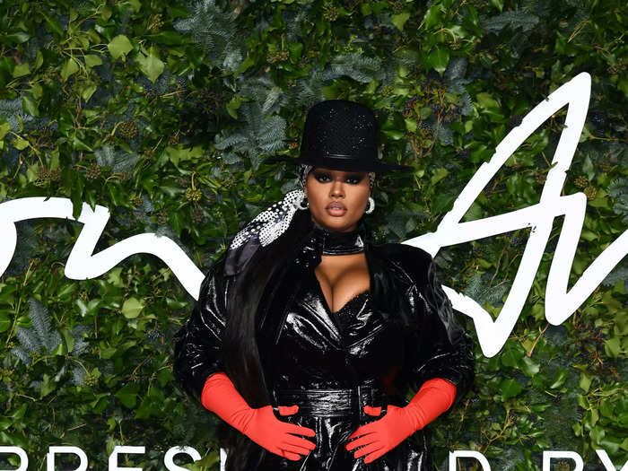 Precious Lee wore a daring black PVC trench with vibrant red gloves.