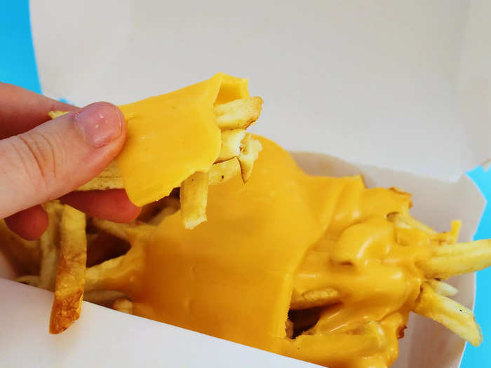 The cheese clung to the top layer of fries.