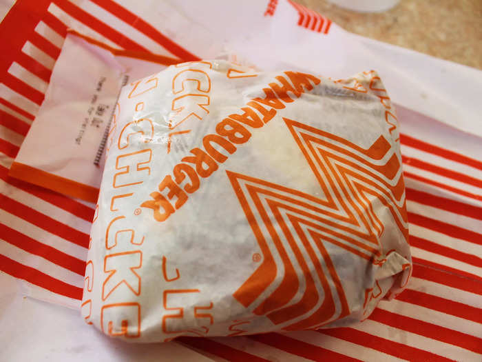 The chicken sandwich came wrapped in paper.