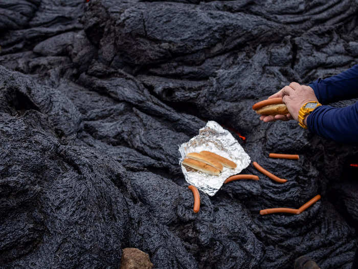 This photo of a man in Iceland cooking hot dogs on a volcanic site two days after it erupted might be most unusual of the bunch.