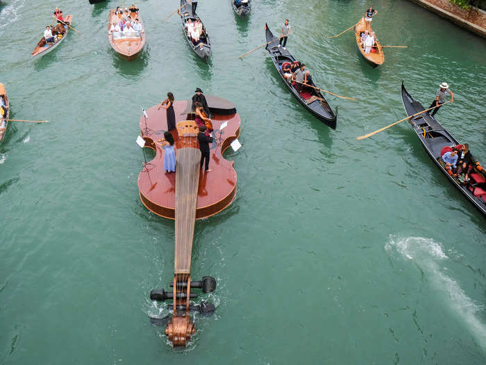 Similarly, this image of a string quartet performing from a violin-shaped boat in Venice, Italy, makes the musicians look tiny.