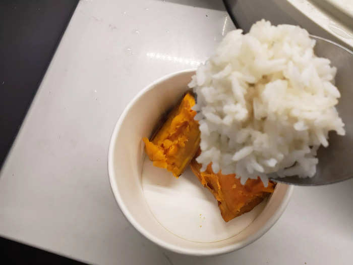 Lay down a rice base next to the sweet potato.