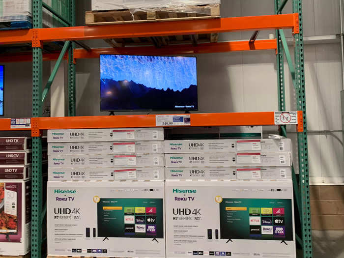 In my location, large electronics are on display near the entrance, with TVs stacked up on huge shelves.