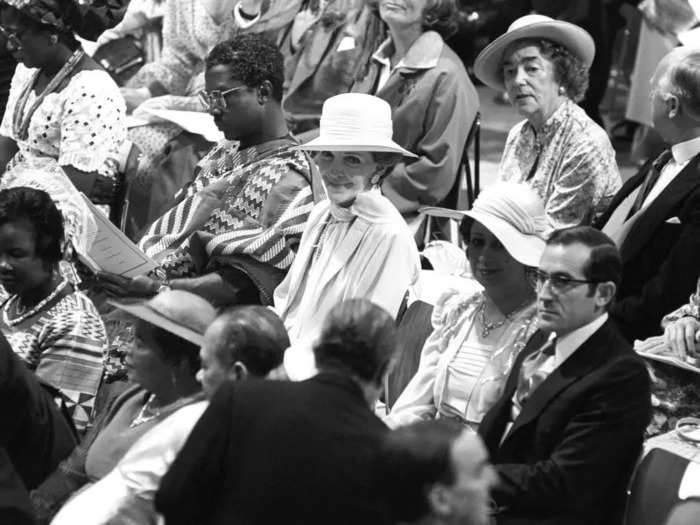 For the actual wedding, she wore a pale pink silk outfit with a matching hat.