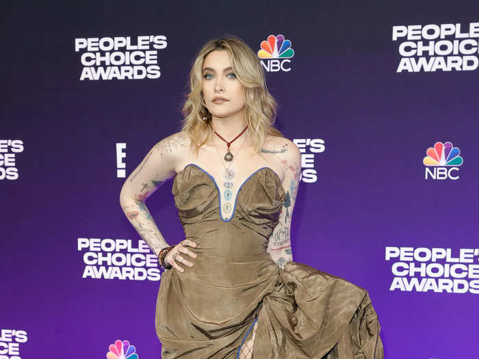 Paris Jackson wowed in a brown Vivienne Westwood dress with a plunging neckline and thigh-high slit.