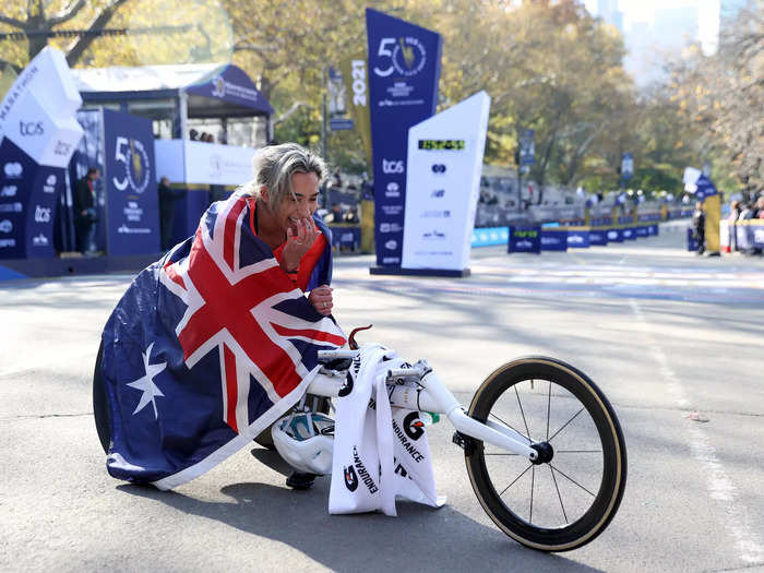 11/07: Madison De Rozario of Australia pauses after the finish line after she won the Women