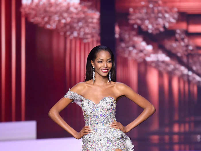 Miqueal-Symone Williams wore a silver dress designed with sheer details and a thigh-high slit to represent Jamaica at the May 2021 pageant.