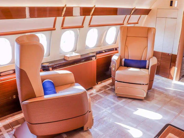 Just like on the Boeing aircraft, the forward compartment offers two types of seating. On one side is a pair of club chairs offering bounds of legroom.