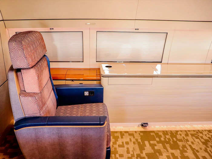 On one side, a pair of club seats offer near-endless legroom. This section is typically favored by the principal flyer during takeoff and landing.