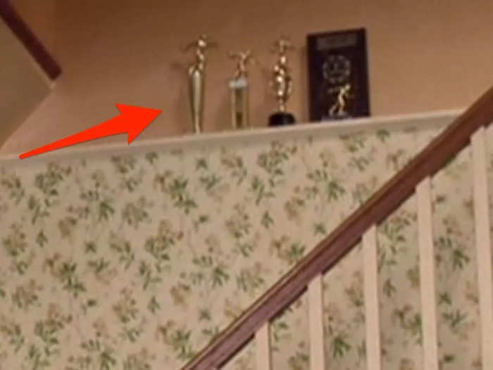 Bowling trophies are seen along the ledge by the staircase of the Parker house in Queens, NY.