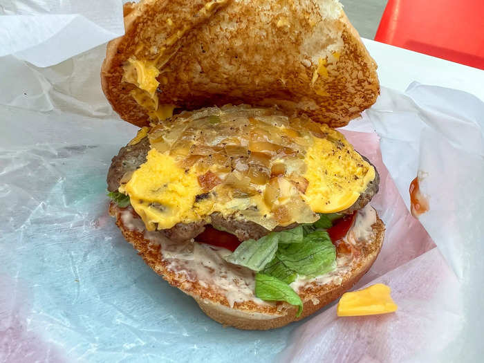 The grilled onions graced the top of the burger along with the cheese, while the lettuce, tomato, pickles, and sauces were below the patty.