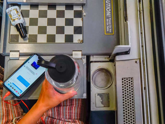 The cup holders in Amtrak roomettes and bedrooms fit a standard 12-ounce water bottle.