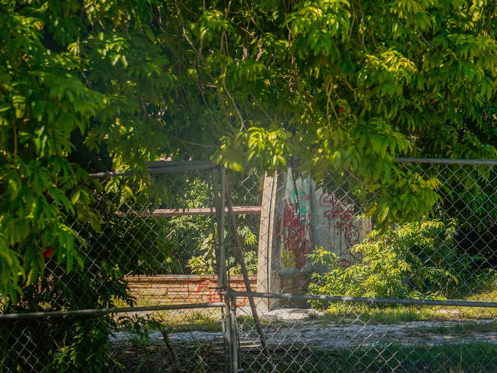 Some of the abandoned structures were fenced off and covered in graffiti.