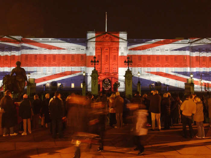 While the royal family cozies up in Sandringham, a festive Union flag is projected on the outside of the palace.