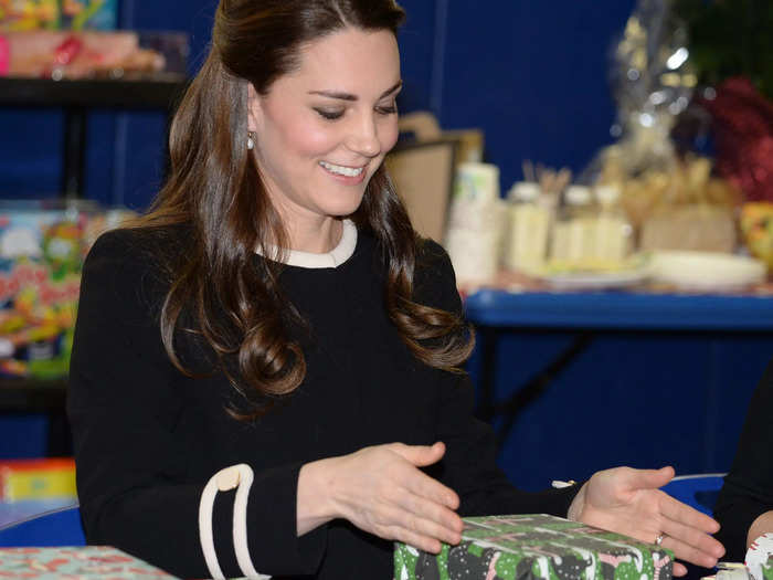 Members of the royal family gather around the tree and exchange hilarious gifts at teatime on Christmas Eve.