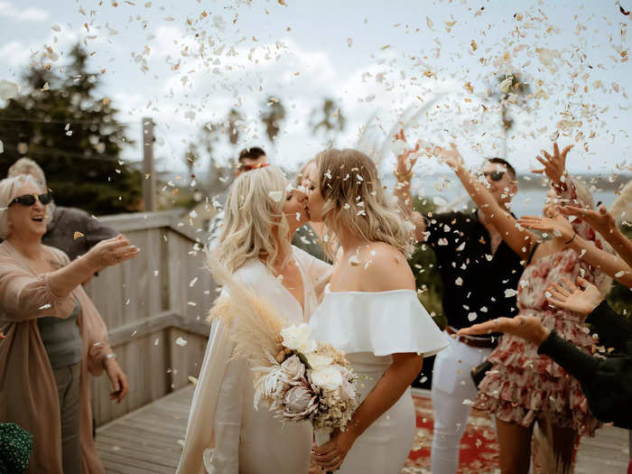 Flower petals showered these newlywed brides at their wedding in Tauranga, New Zealand.