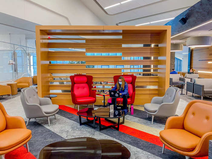 A living room greets passengers as they enter complete with a mix of armchairs and couches.