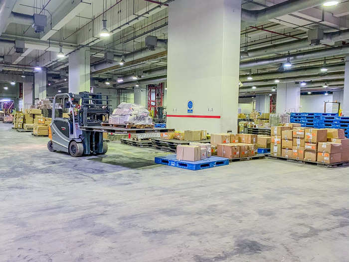 The first two floors are dedicated to breaking down and building up pallets that arrive and depart from the facility. A package might arrive on a pallet from Hong Kong, for example, and then get taken out of that pallet and restacked onto another pallet bound for the US.