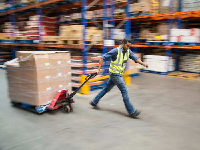 Employees called "water spiders" bring the pallets of packages up a freight elevator to the "stowers."