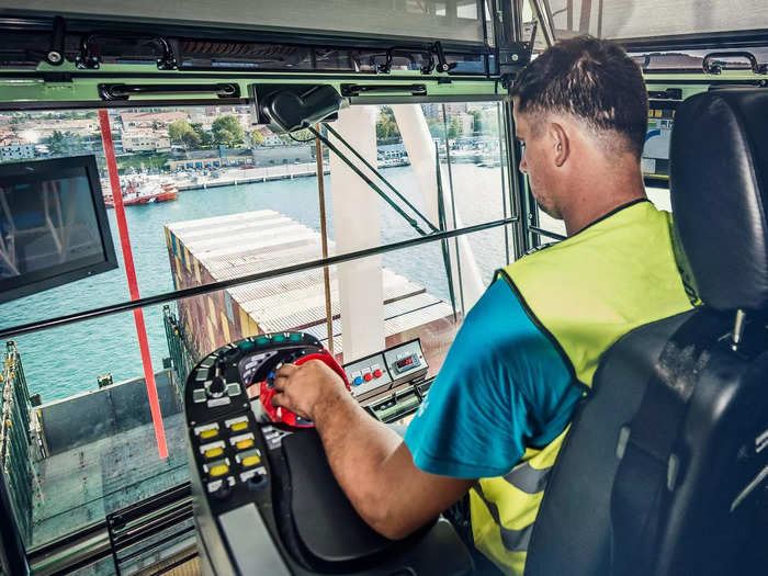 A crane operator picks up the container from hundreds of feet above and loads it into its designated spot on the ship.