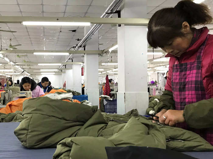 The coat is inspected, packaged, and labeled at the factory.