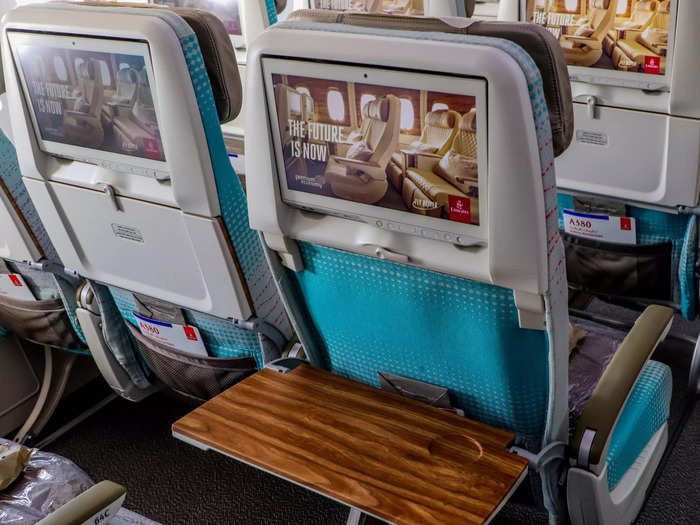 Economy class and its 388 seats will receive new "ergonomically designed" seats that feature tray tables with wood finishes.