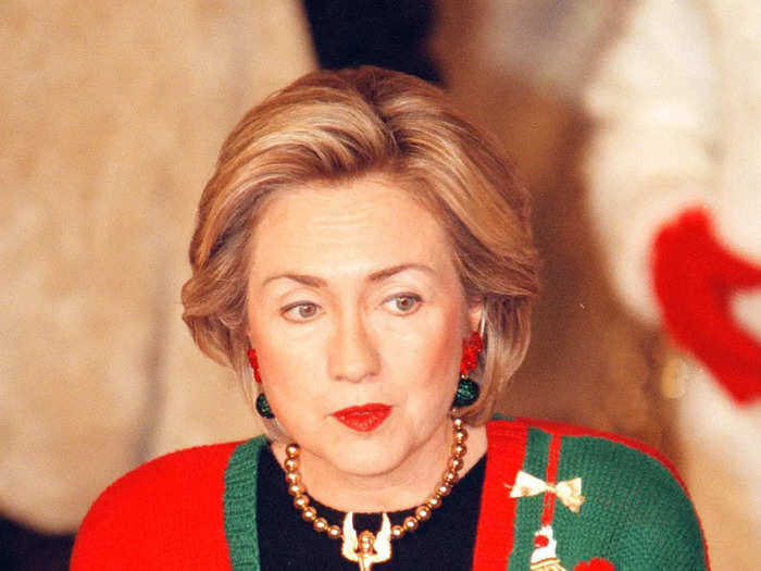 Clinton wore a festive Christmas sweater with an angel necklace in 1998.