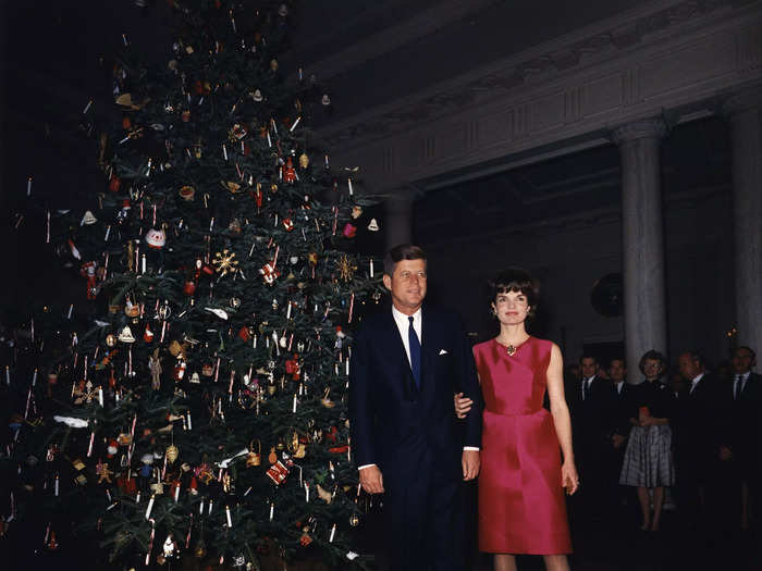 She wore a red silk Givenchy dress for the 1962 White House staff Christmas party.