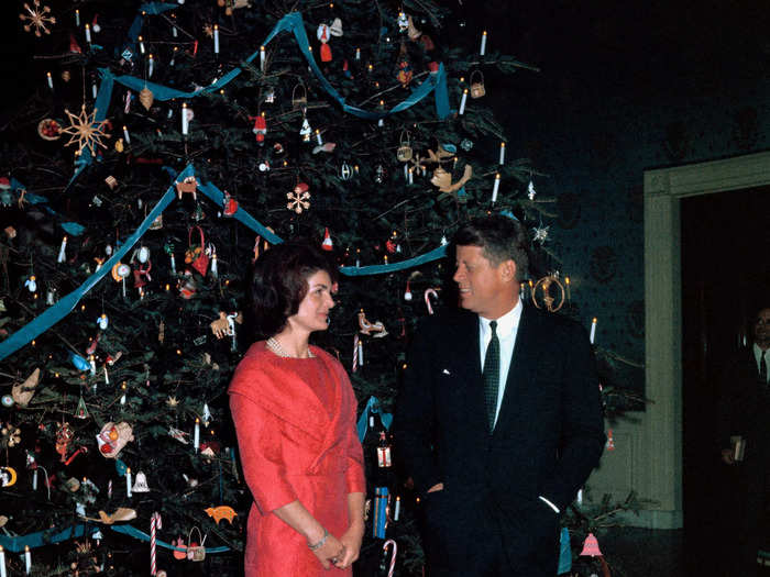 First lady Jacqueline Kennedy, who began the tradition of themed White House holiday decorations, wore a red dress in 1961.