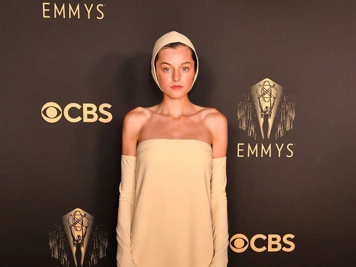 Emma Corrin wore a swim cap-like hat and claws on the Emmys red carpet in September.