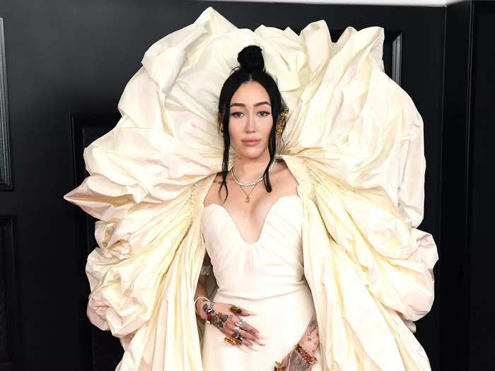 Noah Cyrus wore a Schiaparelli gown with a statement fabric arch that framed her shoulders and head at the Grammy Awards in March.