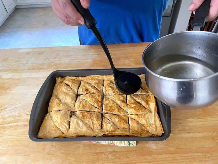 While the syrup is still hot, pour it all over your cold baklava.