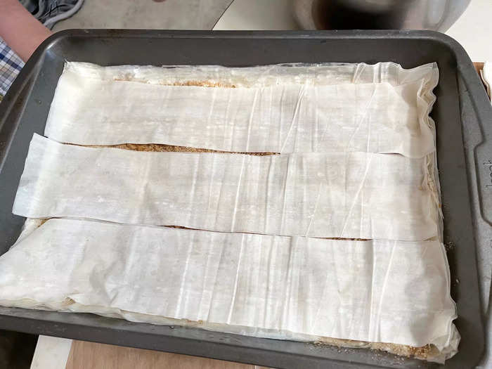 When you reach the middle of your pan, start using the extra phyllo strips.