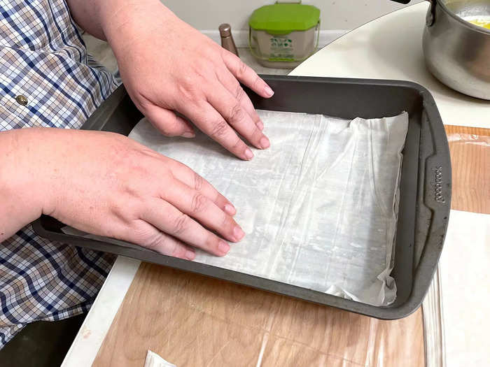 Then start by placing two layers of phyllo in the pan.