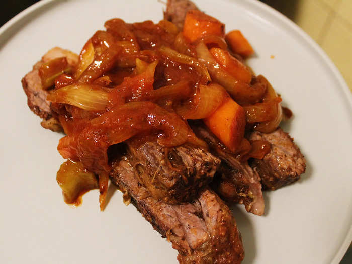 After serving some slices of brisket onto my plate, I topped it with the sauce and the vegetables. The dish looked impressive and tasted delicious.