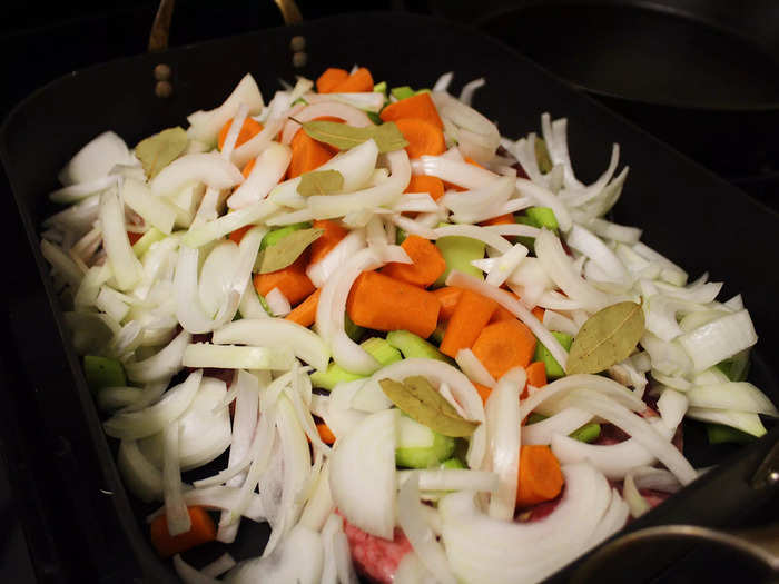 After chopping and slicing the vegetables, I piled them onto the brisket in the roasting pan.