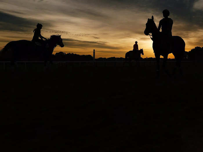 June 2: A group of horses and exercise riders train on the track during a morning workout prior to the 153rd running of the Belmont Stakes.