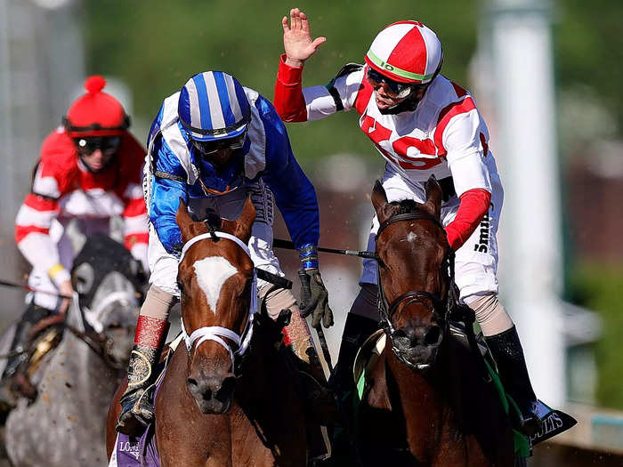 April 30: Jockey Irad Ortiz, Jr. aboard Search Results (right) congratulates jockey John Velazquez aboard Malathaat for winning the 147th Running of the Kentucky Oaks at Churchill Downs.