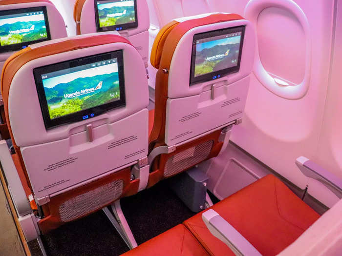 Economy class seats feature standard amenities such as a seat-back entertainment system, USB charging port, and adjustable headrest.