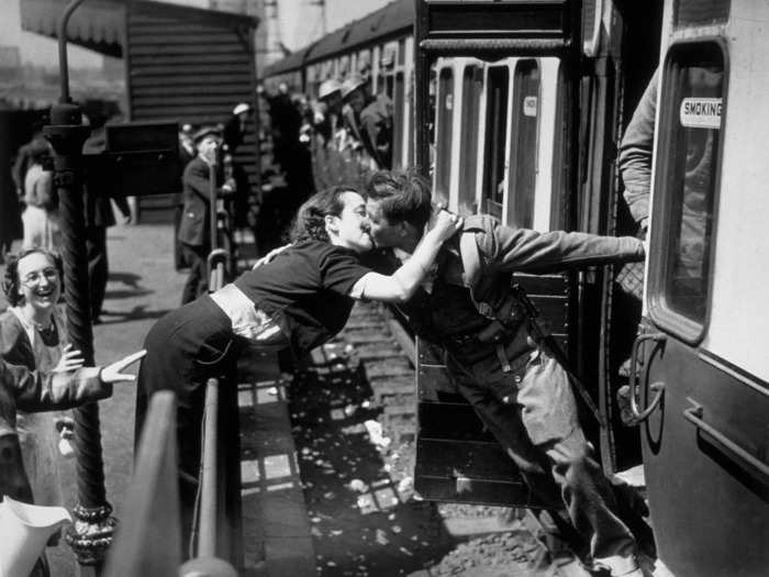 This mid-train ride kiss by a World War II-era couple