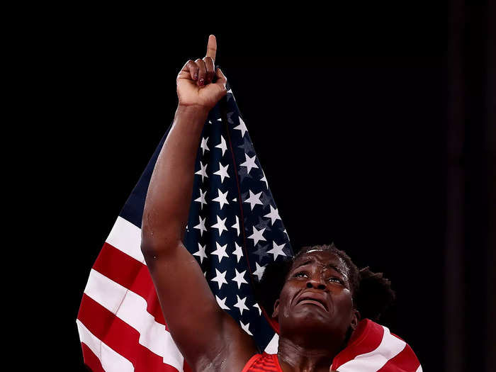 8/3: American wrestler Tamyra Mensah-Stock celebrates her gold-medal victory at the Tokyo Olympics.