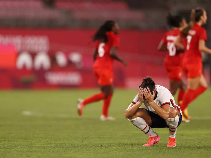 8/2: US soccer star Carli Lloyd holds her head in her hands following the USWNT