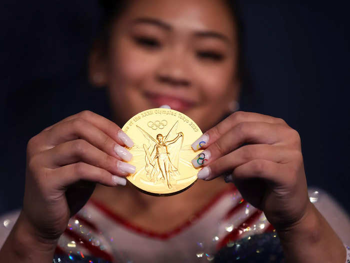 7/29: American Suni Lee poses with her gold medal from the women