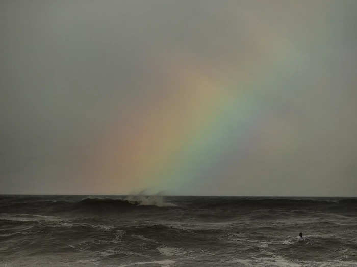 7/27: American surfer Carissa Moore waits for a set as a rainbow appears during the women