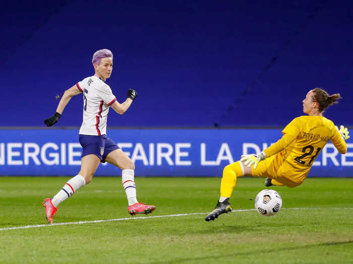 4/13: Megan Rapinoe (left) shoots against French goalie Pauline Peyraud Magnin during a friendly match in Le Havre, France.